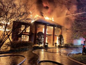 Luxury home engulfed in flames during California wildfire, highlighting risks of limited FAIR Plan coverage