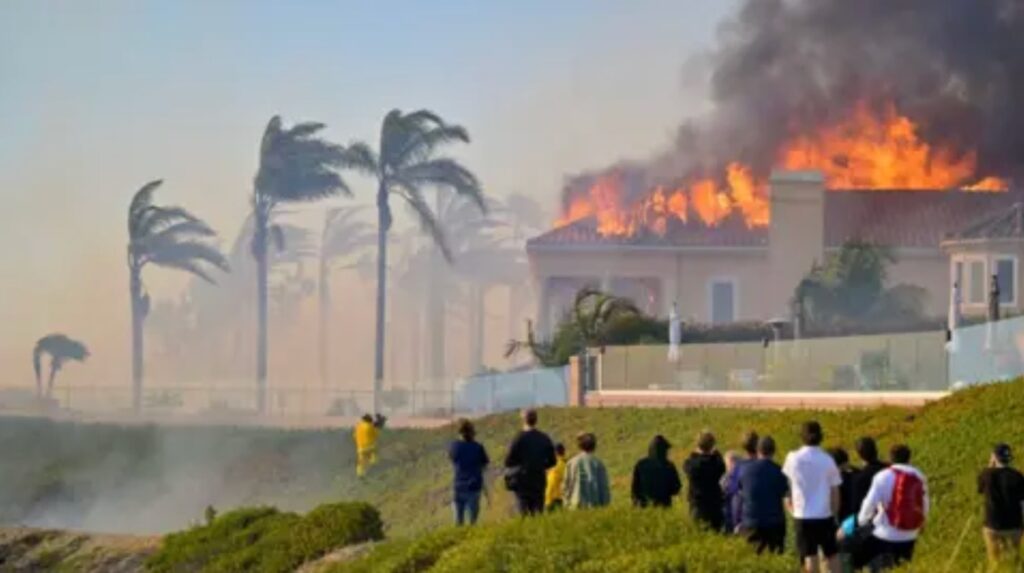 Onlookers watch as a luxury California home burns in wildfire, exposing FAIR Plan insurance coverage gaps