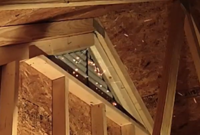 Embers glowing through attic vent in wildfire conditions
