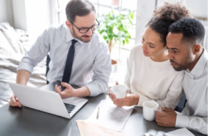 Homeowners meeting with an advisor to review wildfire mitigation and insurance protection options.
